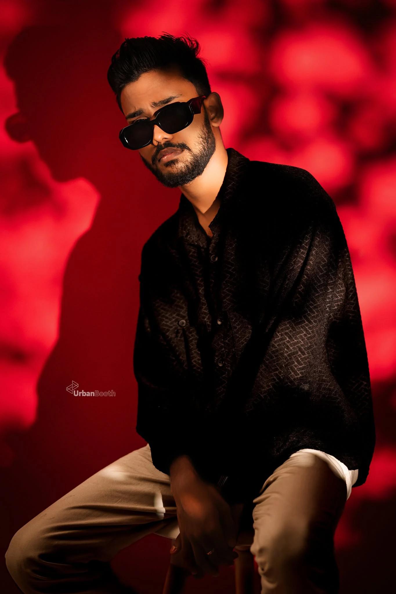 Editorial portrait against a vivid red backdrop